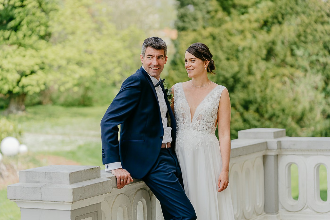 Paarshooting Schlosspark Destedt – Bräutigam lehnt am Balkongeländer, Braut steht neben ihm, gemeinsamer Blick in die Ferne, ruhiger nachdenklicher Moment, Hochzeitsfotografie Schlosspark Destedt Kathrin Skorpel